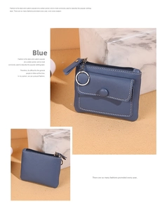 Close-up of blue pebbled leather coin purse with white stitching and key ring