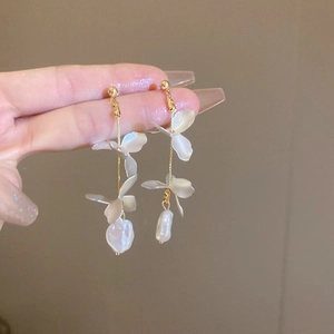 Detailed close-up of petal tassel earrings with irregular pearls and gold-plated chain