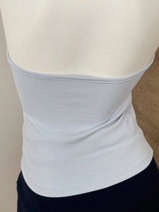 Detailed back view of a light blue halter-style crop top showing the slim-fit cut design