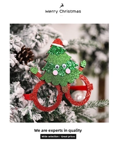 Detail of red glitter Christmas glasses with a green glitter tree and festive hat topper