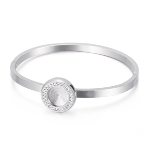 Detail shot of silver stainless steel cuff bracelet with a crystal-encrusted round plate
