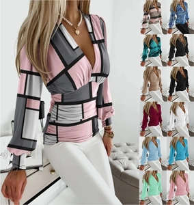 Detail view of V-neck long sleeve blouse featuring geometric patterns and multiple colors