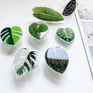Close-up of tropical leaf phone socket grip with glossy resin finish and 3D leaf design