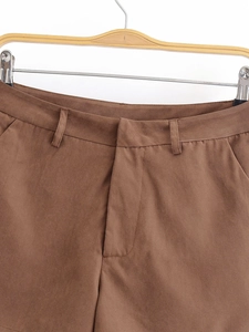 Detailed macro view of the dark brown high-waisted shorts with belt loops and stitching