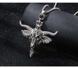 Macro shot of silver bull head pentagram pendant with vintage textured metal finish