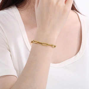 Polished gold paperclip link bracelet on model wrist for trendy fashion style