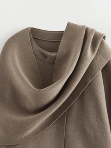 Detail of soft dark brown knitted fabric texture and layered collar on a winter cardigan