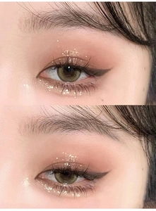 Close-up of warm brown and green colored contact lenses with glitter eye makeup effect