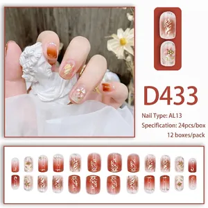 Short red gradient press-on nails set with pearls, floral art and gold accents