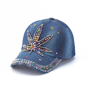Blue denim baseball cap featuring colorful rhinestone marijuana leaf embroidery design