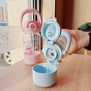 Close-up of kids water bottle showing the pouring mechanism and silicone base sleeve