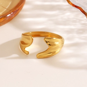 Modern irregular golden stainless steel open ring with a fluid streamlined metal design