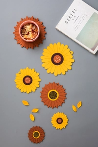 Macro detail of thick sunflower shaped heat-resistant silicone table mats in various sizes