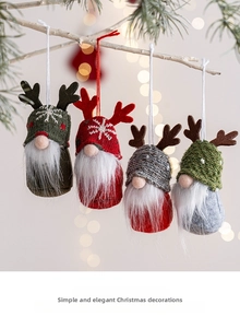 Detail of four Christmas gnome ornaments with knit hats and plush beards on pine branches