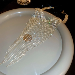 Macro view of gold rhinestone tassel necklace with sparkling crystals and fine details