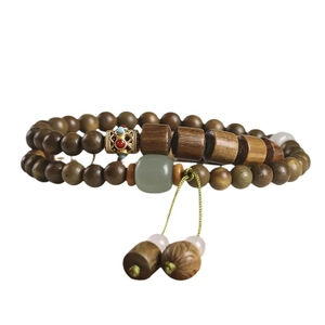 Double-loop green sandalwood beaded bracelet with lotus pendant and silk tassel