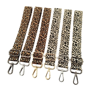 Detail showing leopard jacquard bag straps with gold, silver and gunmetal hardware