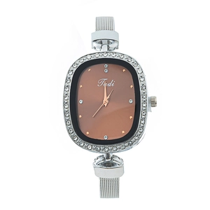Detail shot of oval rose gold quartz watch with silver mesh band and rhinestone bezel