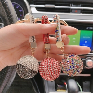 Close-up of sparkling crystal ball keychains with rhinestone straps in diverse colors