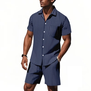 Detail of navy blue striped linen set showing short sleeve shirt pocket and button-down front
