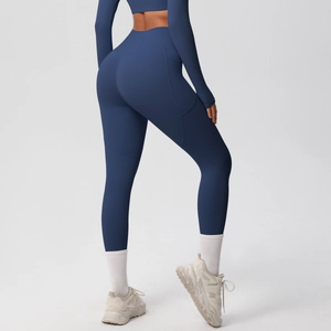Detail view of high waist navy blue yoga pants featuring functional side pockets for storage