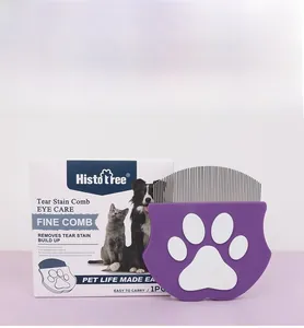 Close-up of pet eye care fine comb with purple handle and steel teeth for cats and dogs