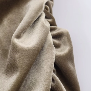 Macro shot of premium taupe velvet fabric showing soft texture and pleated details