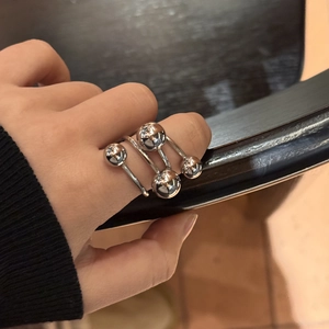 Polished silver stainless steel spiral ring with spherical beads in a layered design