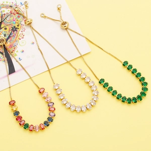 Macro view of adjustable tennis bracelets with colorful oval zircons and gold chain detail