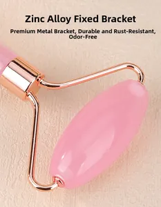 Detail of rose gold zinc alloy bracket on a pink quartz facial massage roller