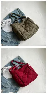 Detail of olive green and burgundy quilted tote bags with adjustable wide shoulder straps