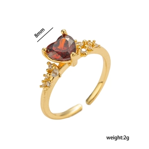 Elegant gold heart ring with red crystal stone and micro-inlaid zircon accents