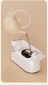 Detail of filling the 140ml large water tank of the portable white handheld garment steamer