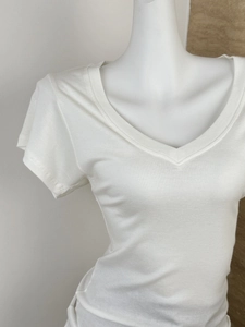 Close-up of white V-neck T-shirt in tencel wool with a layered minimalist design