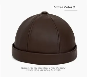 Detail of coffee brown PU leather brimless dockers hat with multi-panel stitching