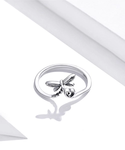 Detailed close-up of s925 silver ring featuring dragonfly and heart motifs on white background