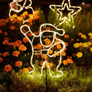 Solar Christmas yard stakes with neon LED Santa, snowman, and star motifs in a garden