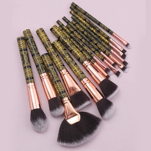 15pcs professional makeup brush set with black gold floral handles on pink background