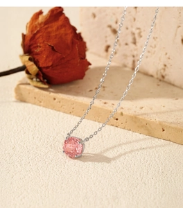Detailed view of S925 silver necklace with pink rose-cut diamond on stone surface