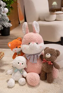 Detail of plush animal dolls featuring textured lamb wool fabric and cute plaid bowties