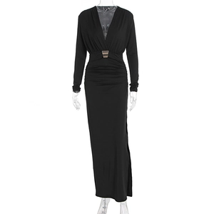 Detail of elegant black slim-fit dress with deep V-neck and golden buckle at the waist