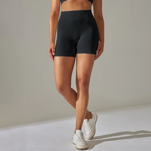 Detail view of high-waisted seamless yoga shorts with wide ribbed waistband in black color