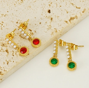 Detailed macro view of vintage emerald and ruby earrings on a natural stone base