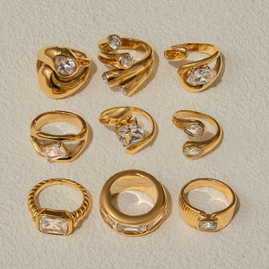 Detailed collection of nine gold-plated stainless steel rings with zircon settings