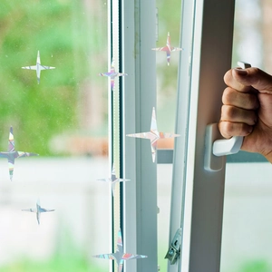 Close-up of holographic star window stickers showing rainbow prism light reflection effect