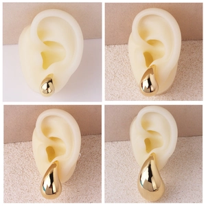Polished gold teardrop earrings in four sizes shown on model for minimalist style