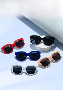 Detailed view of square oversized sunglasses in red, blue, beige, and white frames