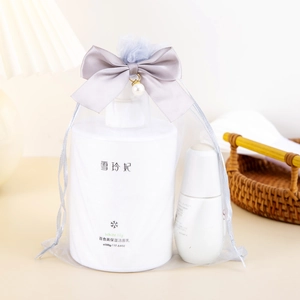 Japanese skincare set in a grey organza gift bag with a large bow and pearl charm