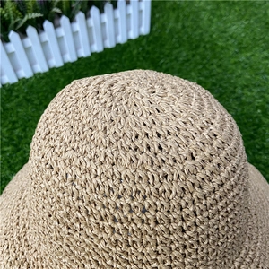 Close-up of hand-woven straw hat crown showing detailed texture and natural fibers