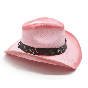 Macro detail of pink straw cowboy hat with embroidered floral leather band and metal studs